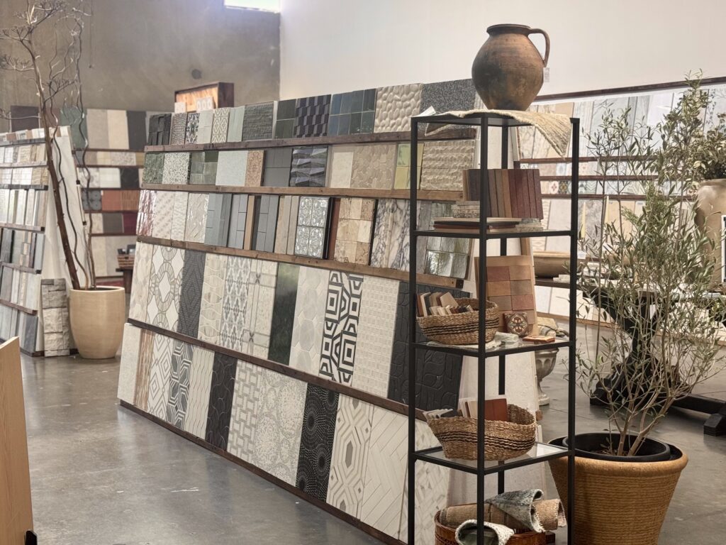 Tile samples displayed beside black shelving in the showroom