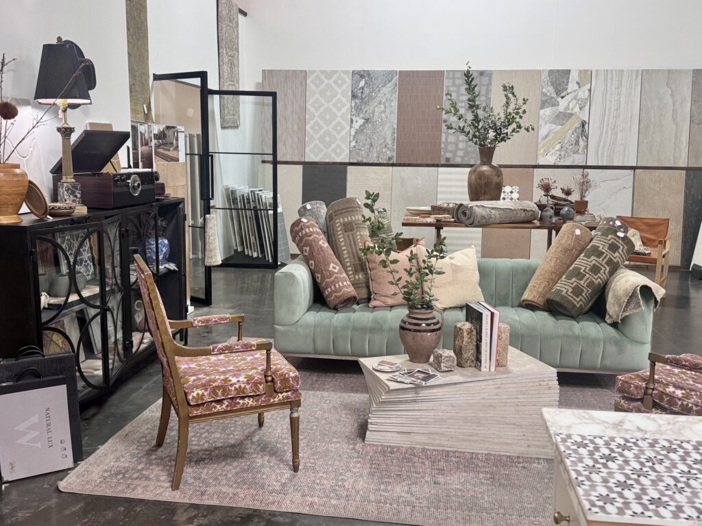 Green sofa and curated furnishings in the North County Tile and Stone showroom